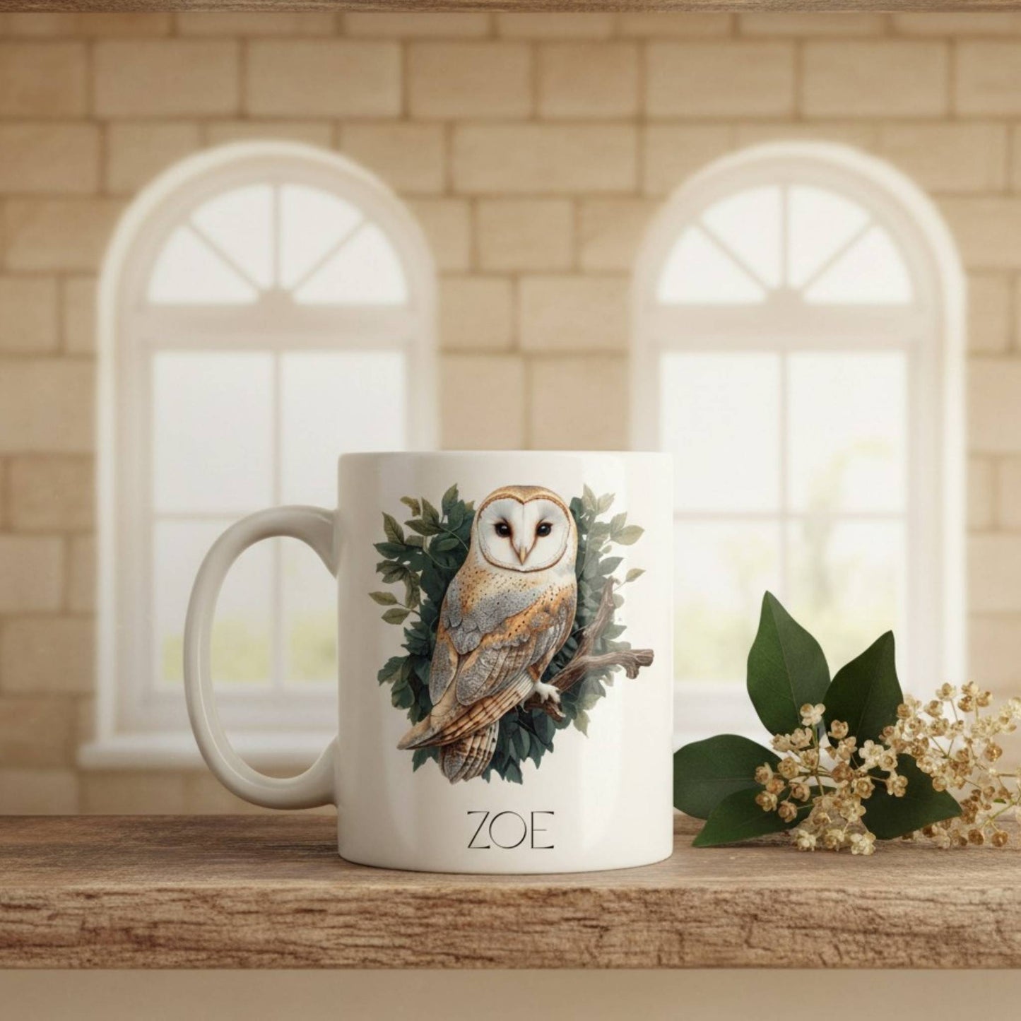 Mug with owl design and 'ZOE' text on a wooden surface with a window background