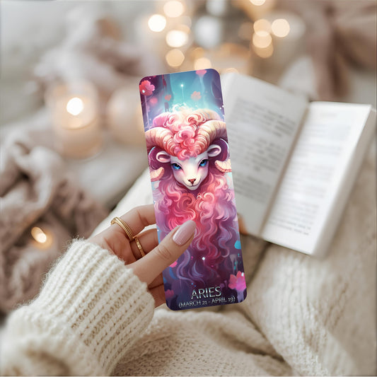 Bookmark with Aries zodiac design held by a person wearing a white sweater.