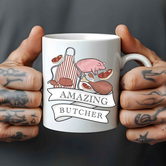 Mug with 'Amazing Butcher' design held by tattooed hands against a dark background