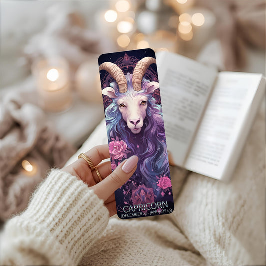 A person presents a book adorned with a goat image bookmark and wording Capricorn on the front, emphasizing its unique and engaging design.