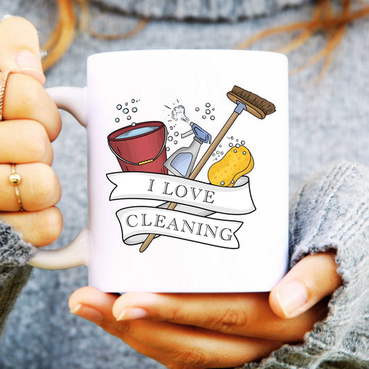 White mug with cleaning-themed design and 'I Love Cleaning' text held by a person.