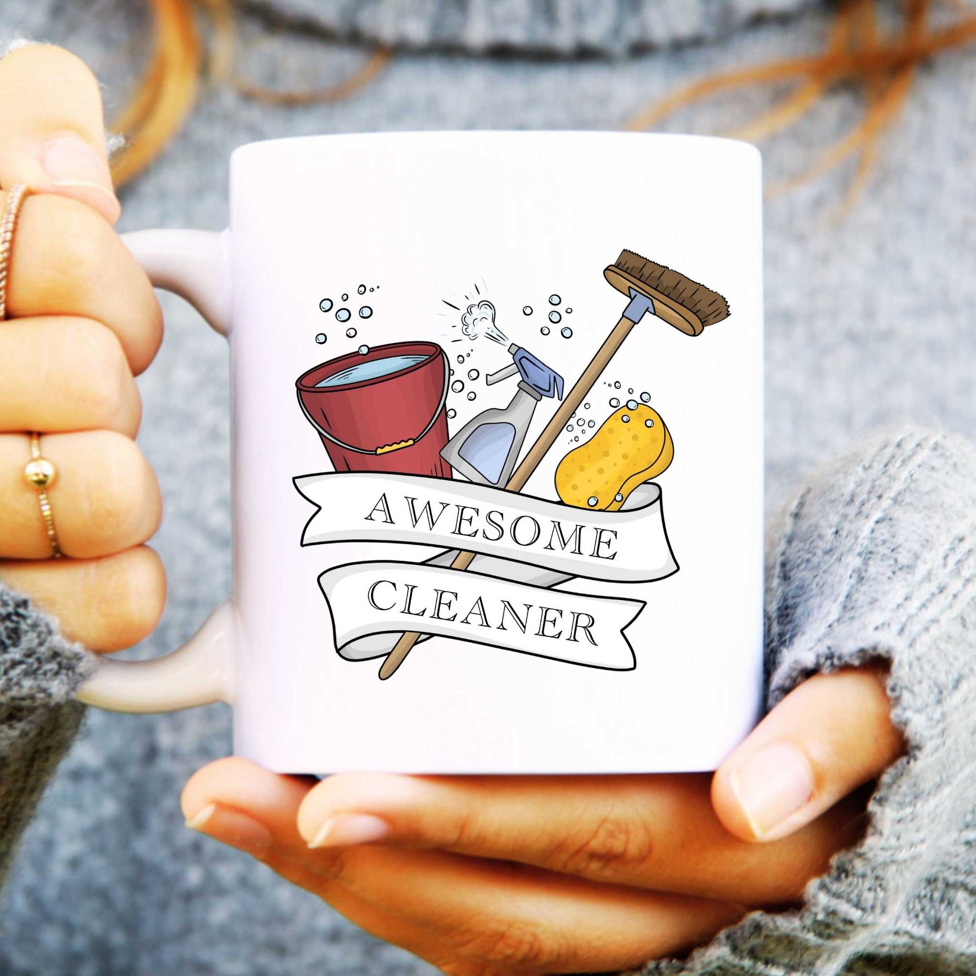 Mug with cleaning-themed design and 'Awesome Cleaner' text held by a person.