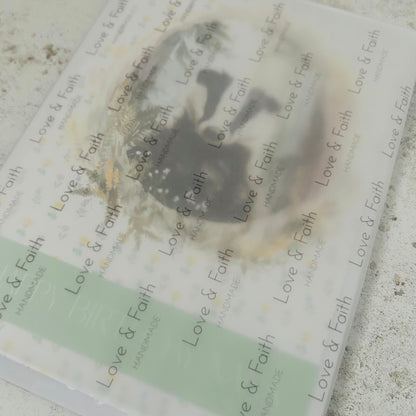 Product packaging with 'Love & Faith' branding on a textured surface