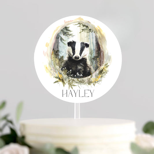 Decorative cake topper with a badger illustration and 'Hayley' text on a white background.