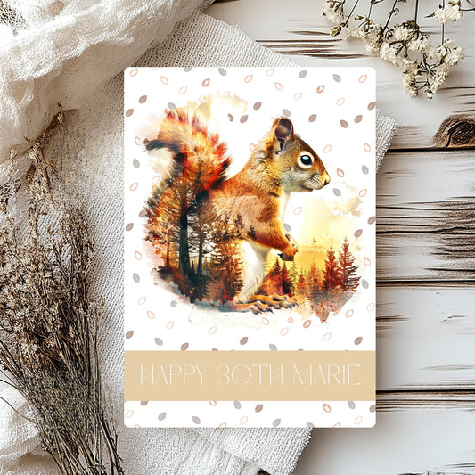 Greeting card with a squirrel illustration on a wooden surface with decorative elements.
