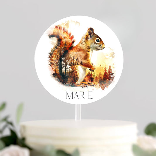 Round cake topper with a squirrel design and the name 'MARIE' on a white background.