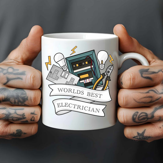 White mug held by tattooed hands with electrician-themed design and text 'Worlds Best Electrician'.