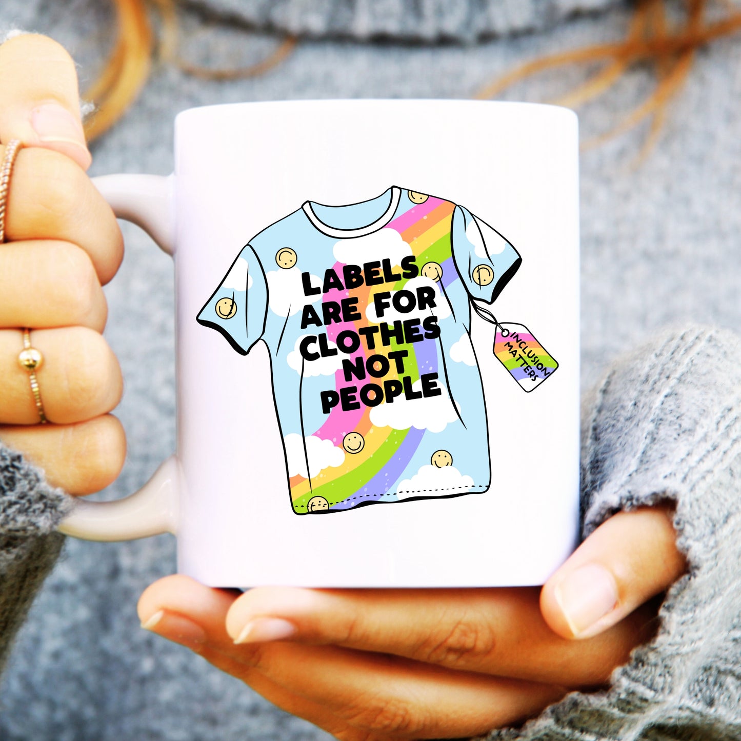 White mug with a t-shirt on with rainbow design, text reads "Labels are for clothes not people"