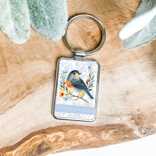 Keychain with a bird design on a wooden surface