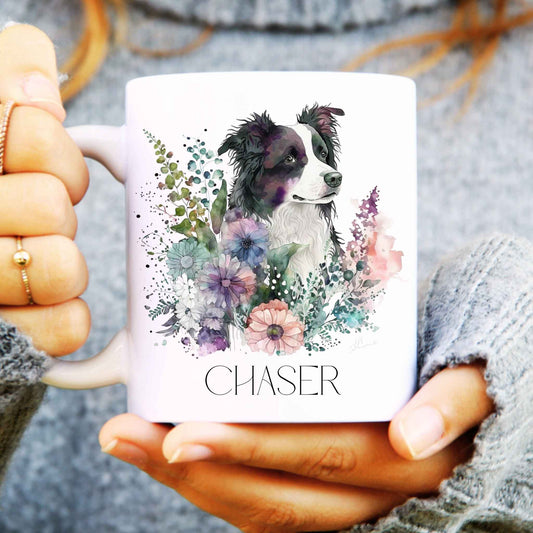 Person holding a mug with a border collie dog illustration and floral design, labelled 'CHASER'.