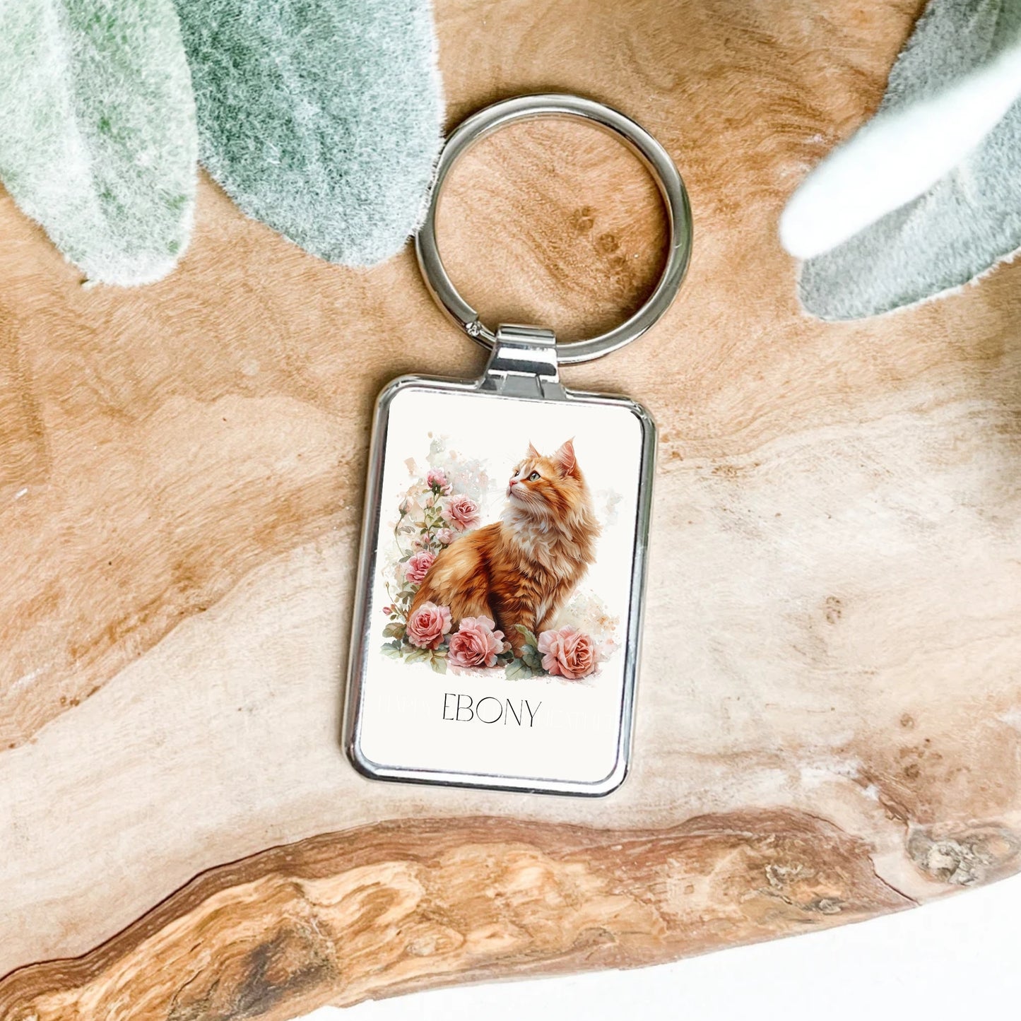 Keychain with a cat design on a wooden surface personalised.