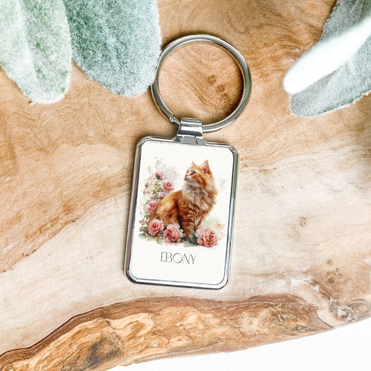 Keychain with a cat design on a wooden surface personalised.