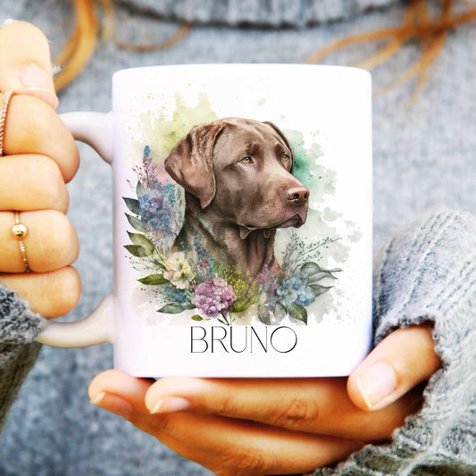 White ceramic mug with a watercolour chocolate Labrador surrounded by flowers and personalised with a name.
