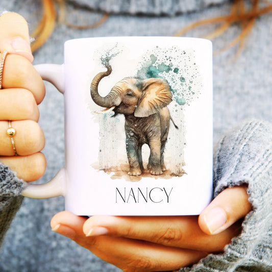 Ceramic mug held in a hand with playful elephant and personalised.