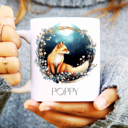 Watercolour fox design surrounded by flowers and the moon in the background on a ceramic mug and personalised with a name.