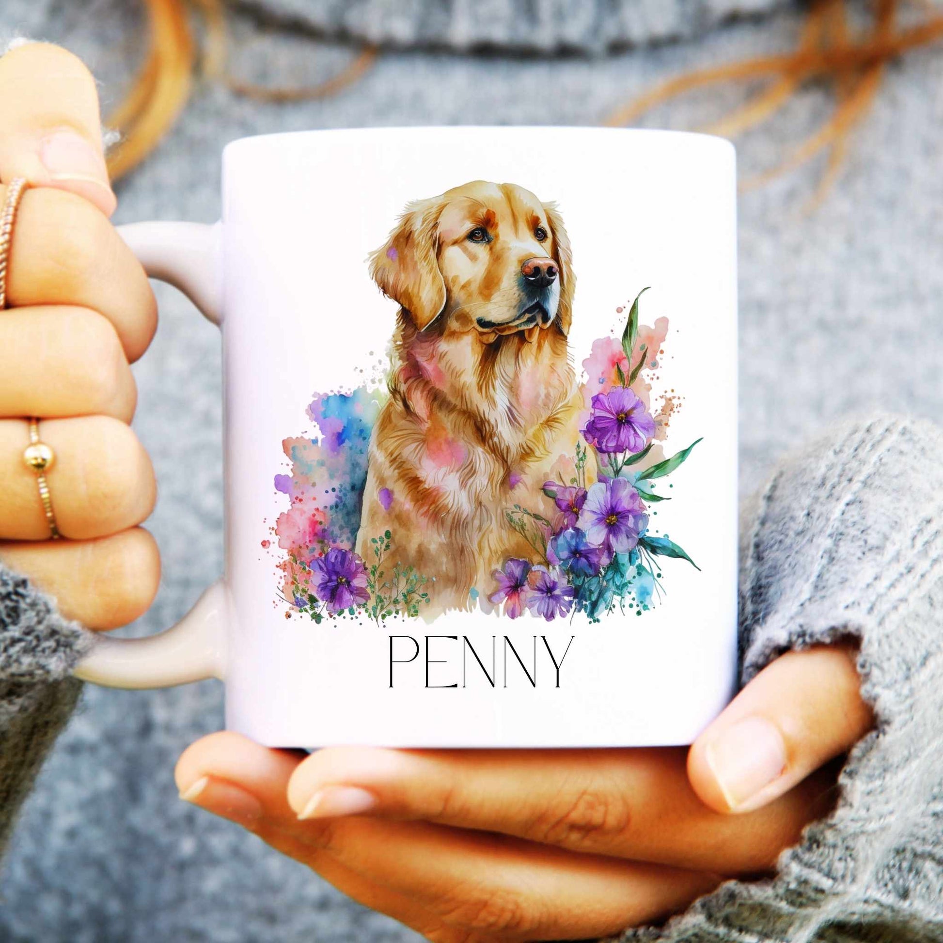 Person holding a mug with a golden retriever dog illustration and 'PENNY' text