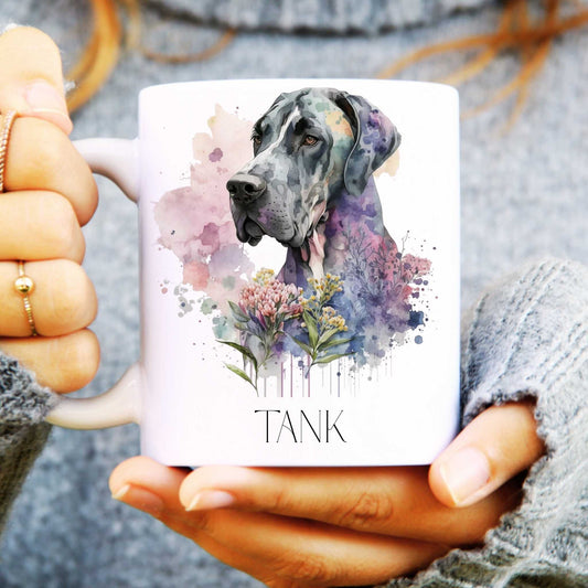 Person holding a mug with a Great Dane dog illustration and 'TANK' text