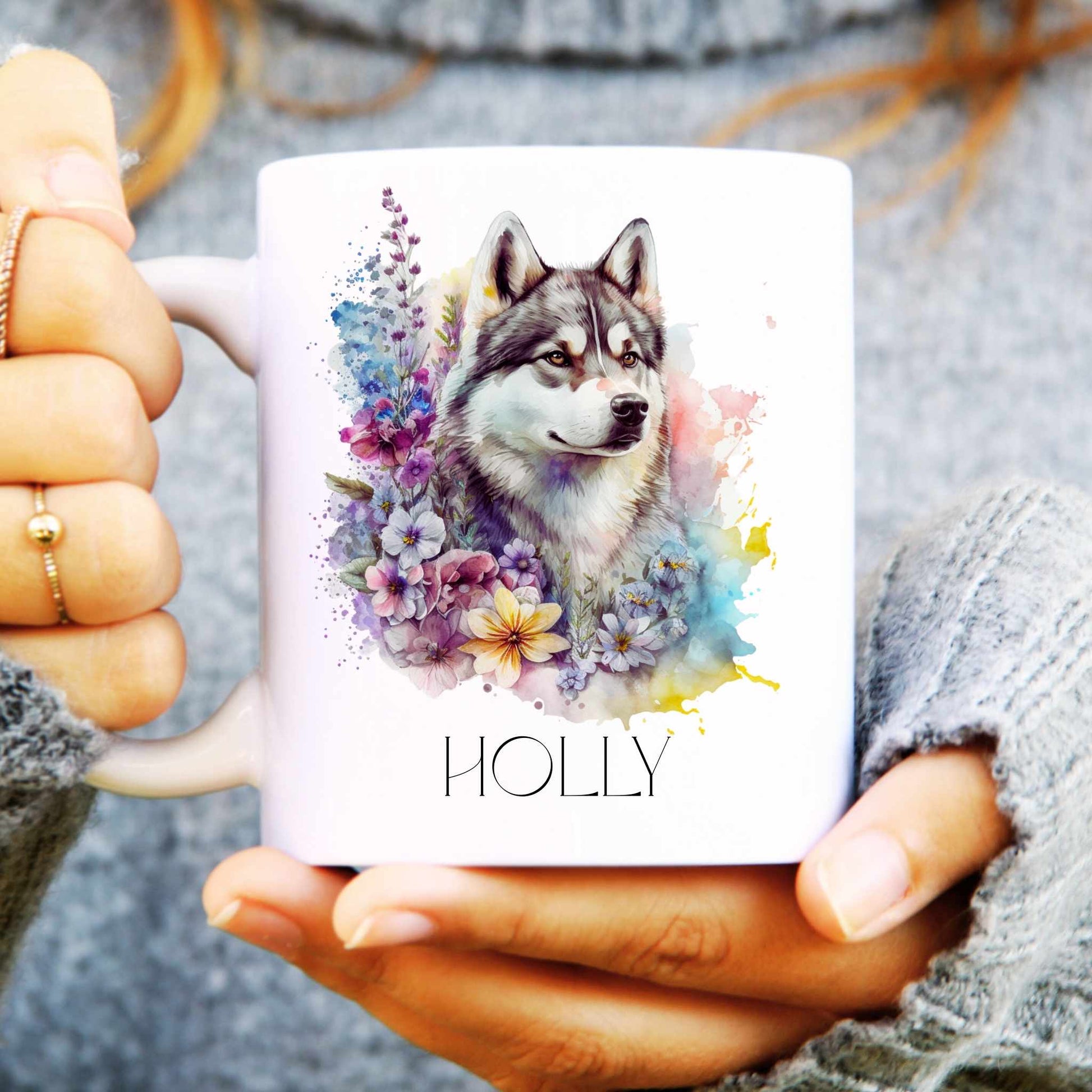 White mug with a husky and floral design held by a person