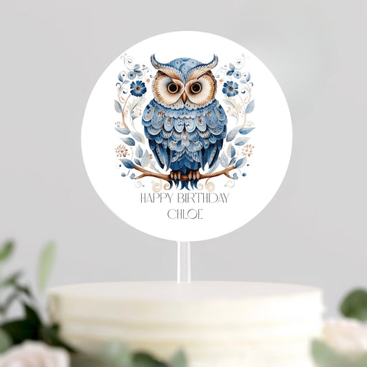 Cute blue owl cake topper adorned with a vibrant "Happy Birthday" message, adding charm to any birthday cake.