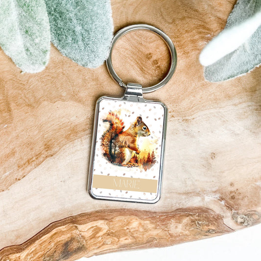 Keychain with a squirrel design on a wooden surface