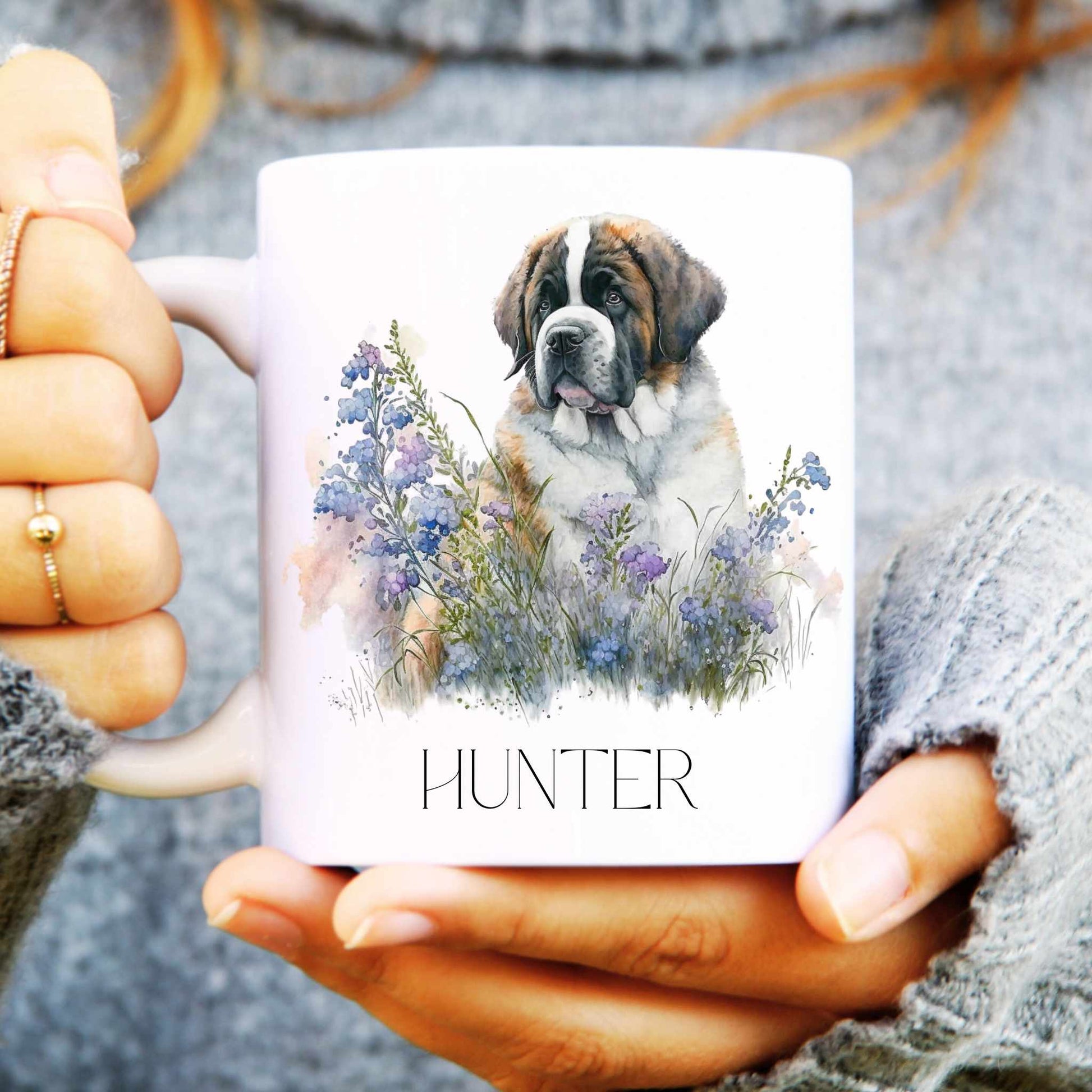 Person holding a St Bernard mug with a dog illustration and 'HUNTER' text