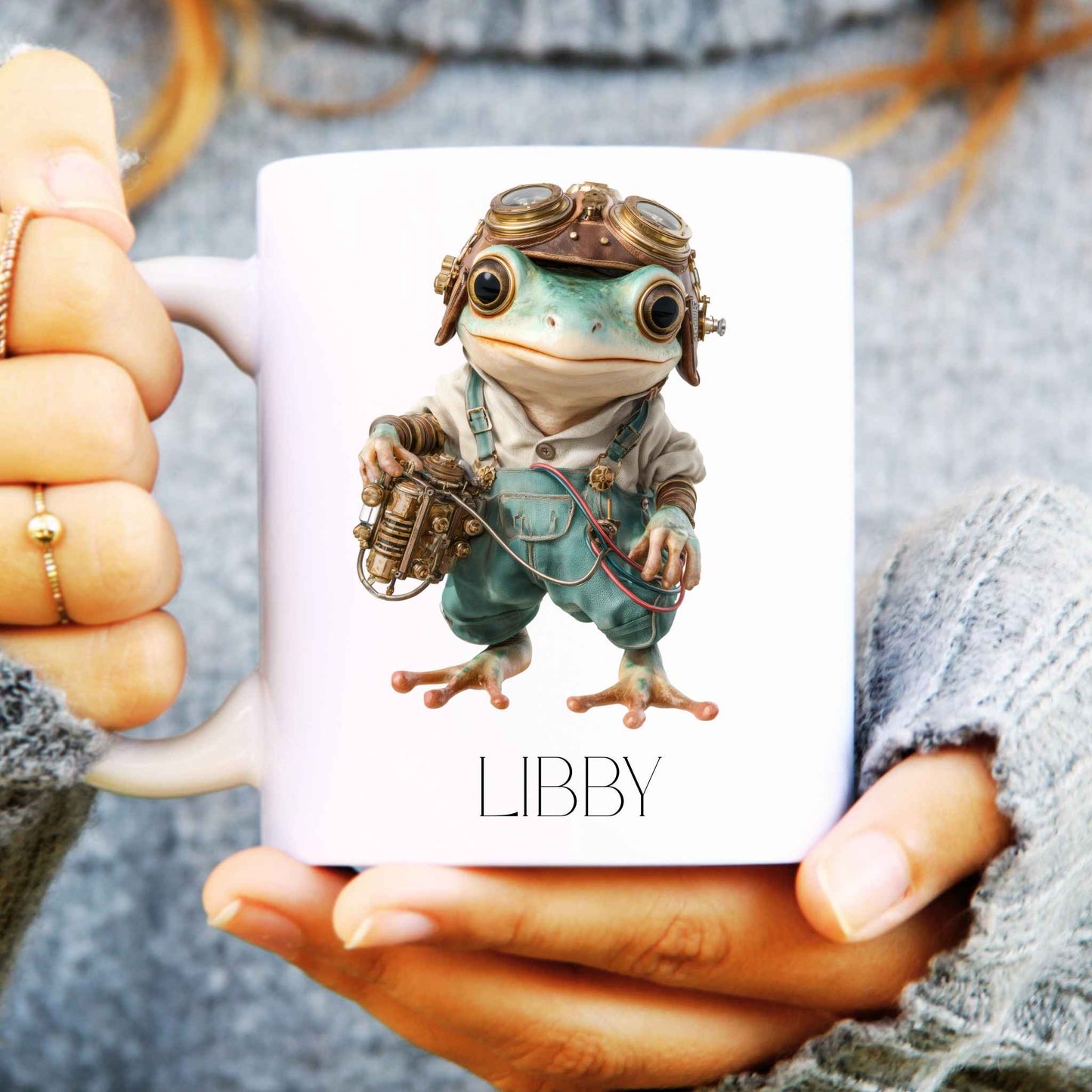 Steampunk frog design personalised on a white ceramic mug held in someone's hands.