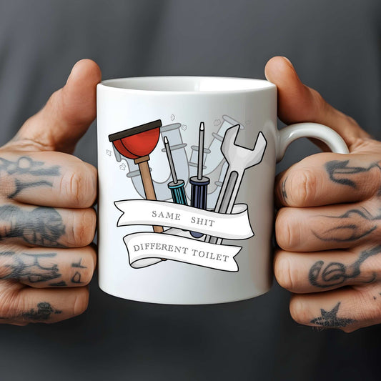 White mug held by tattooed hands with plumbing tools illustration and text.