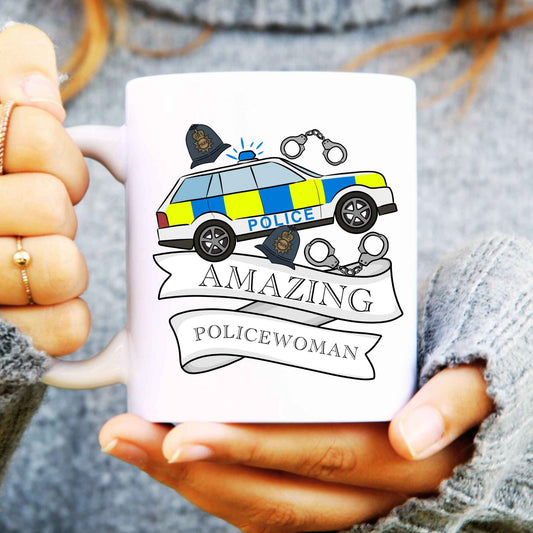 White mug with a police car design and 'Amazing Policewoman' text held by hands.
