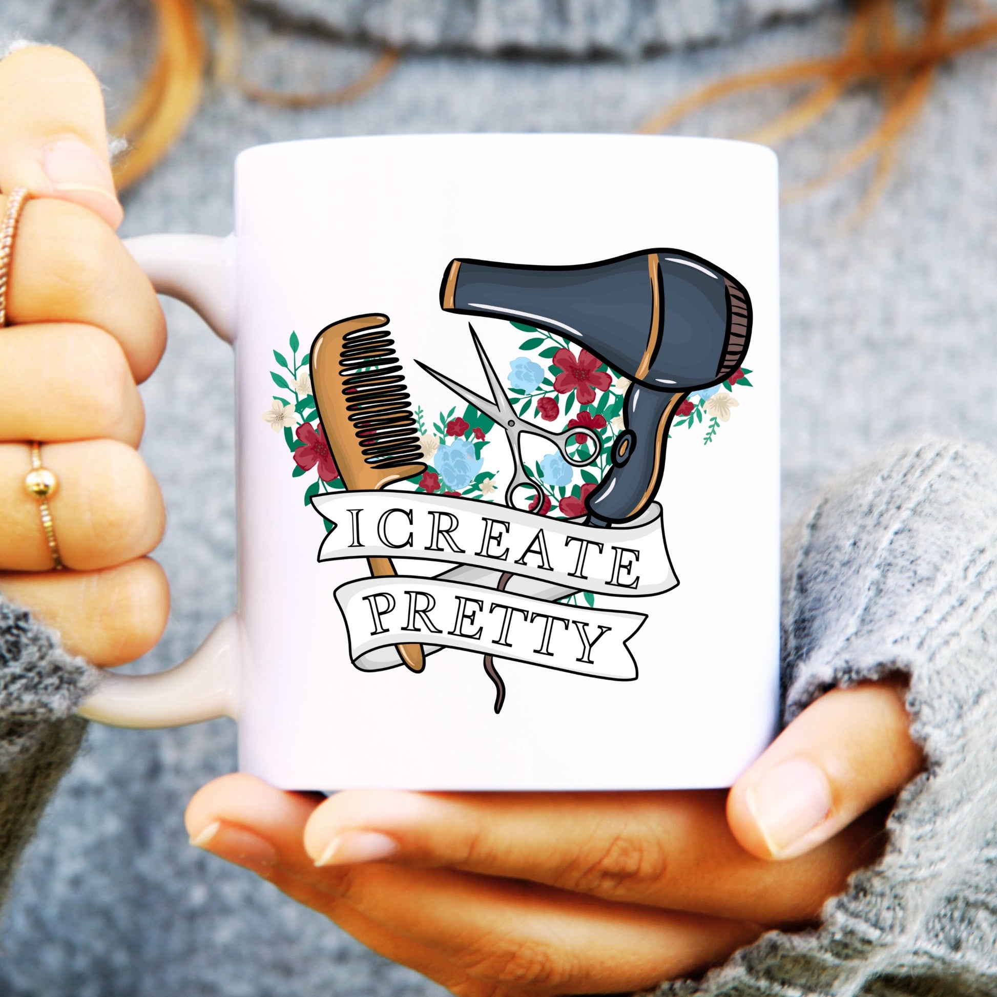 White mug held by hands with a hair styling tool design and 'I Create Pretty' text.