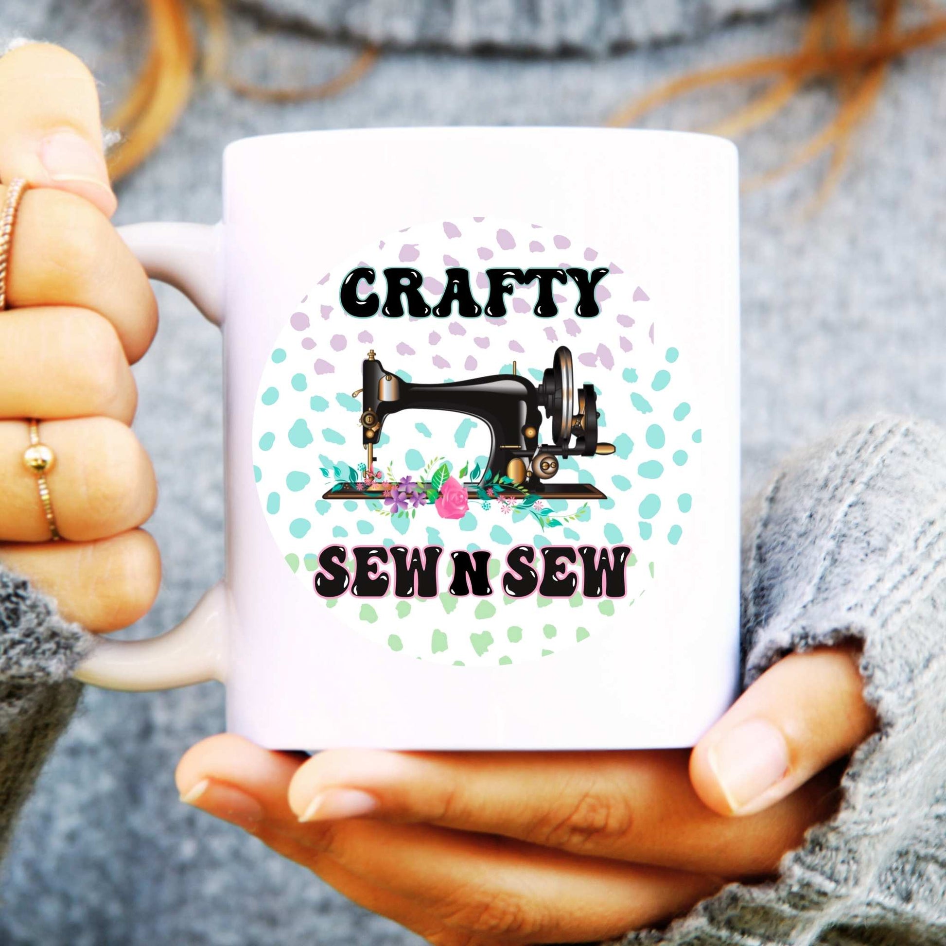 White mug with 'Crafty Sew n Sew' design held by a person.