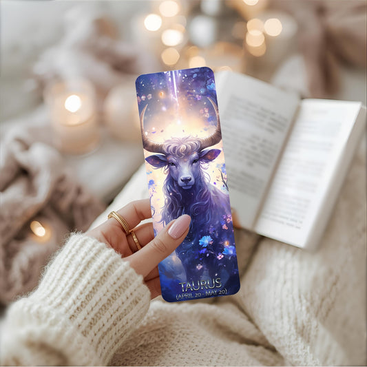 A person holds a bookmark adorned with a prominent bull image, highlighting its captivating theme with Taurus wording.