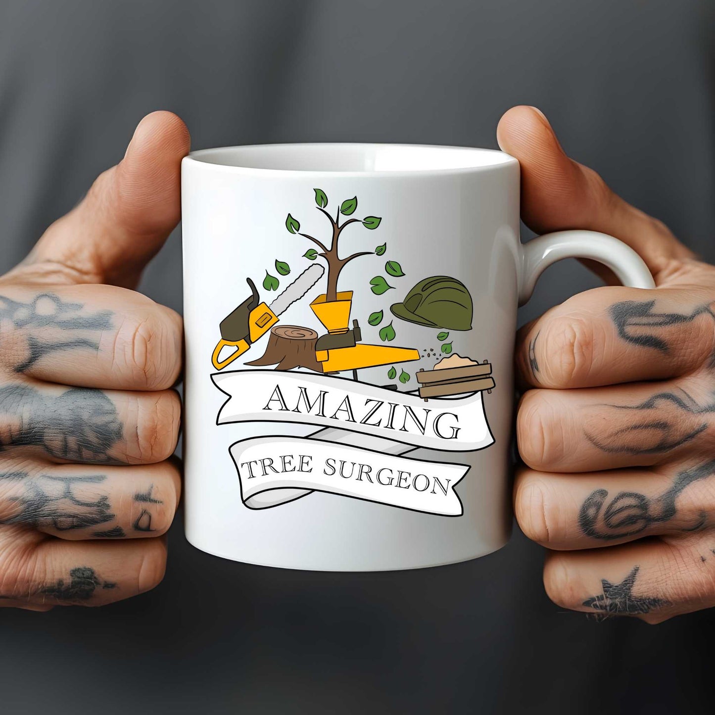 White mug held by hands with tattoos, featuring a design of tree care tools and 'Amazing Tree Surgeon' text.