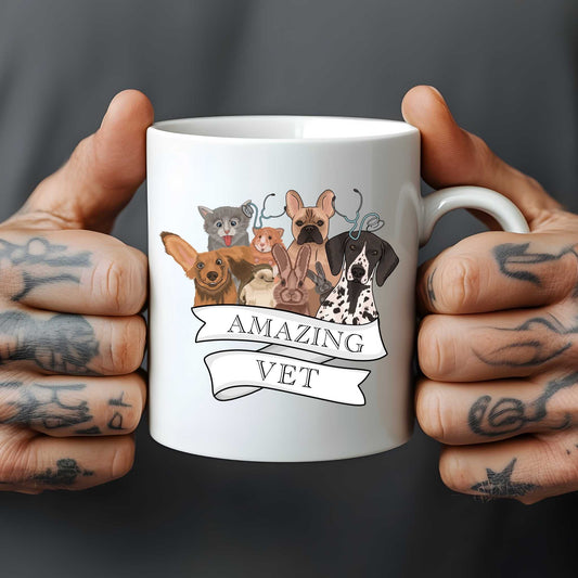 White mug held by tattooed hands with illustrations of animals and 'Amazing Vet' text on a dark background