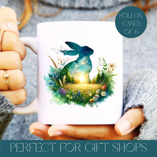 Mug with a rabbit and nature design held by hands, with text about cases of 6 and gift shops, wholesale.