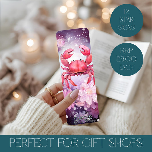 Bookmark with crab design representing Cancer star sign held by a hand, blurred lights in the background